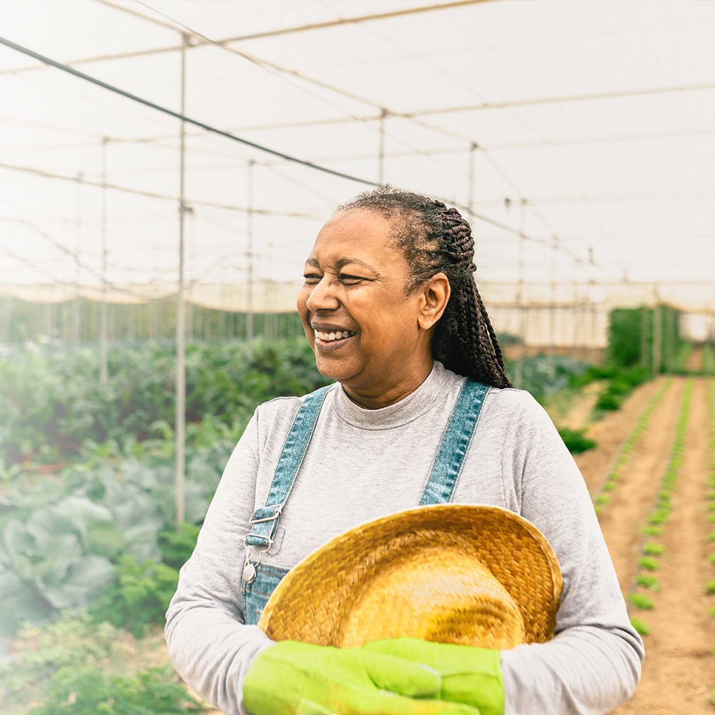 Farmer with sunhat checking on crops